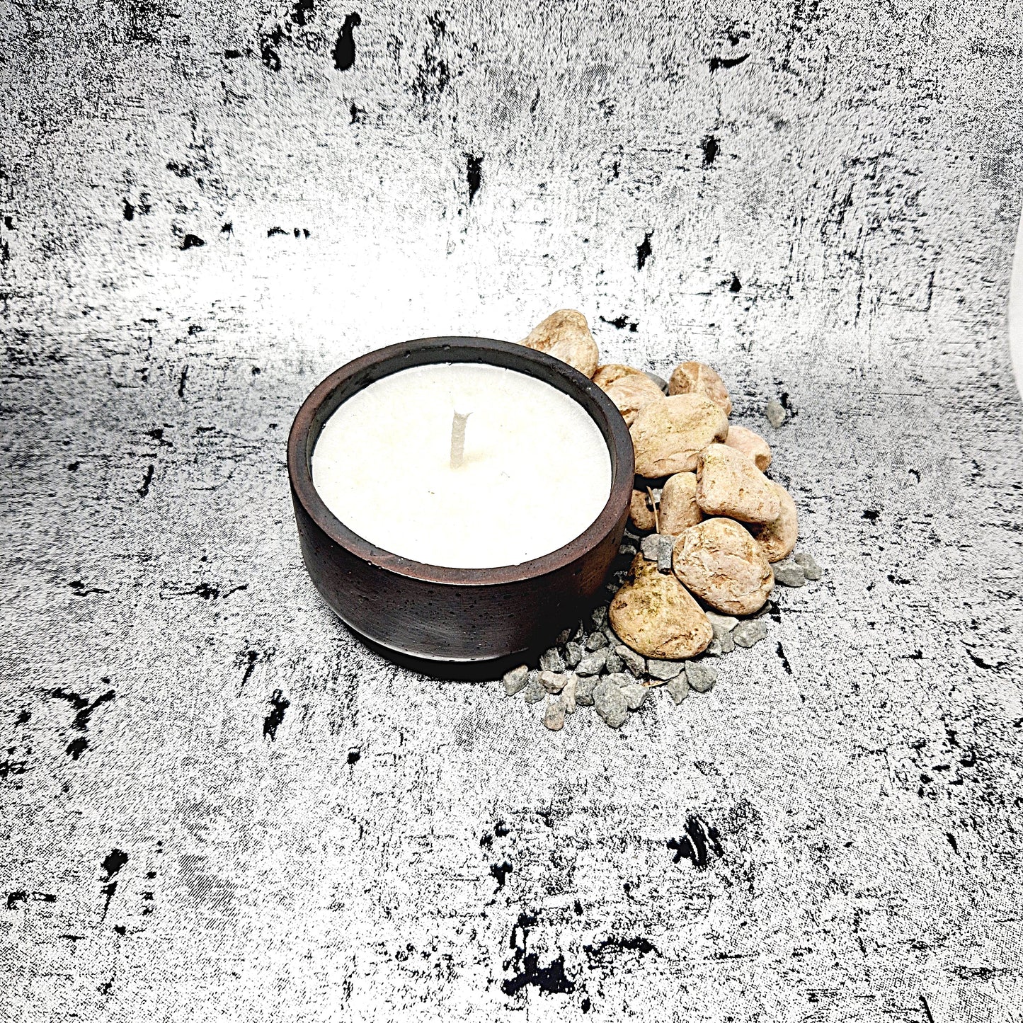 Champagne and rose candle in a concrete jar