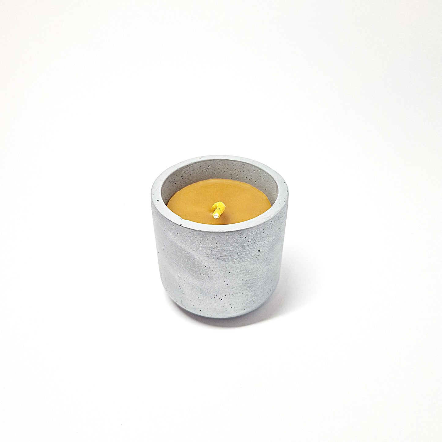 Beeswax candle in a concrete jar