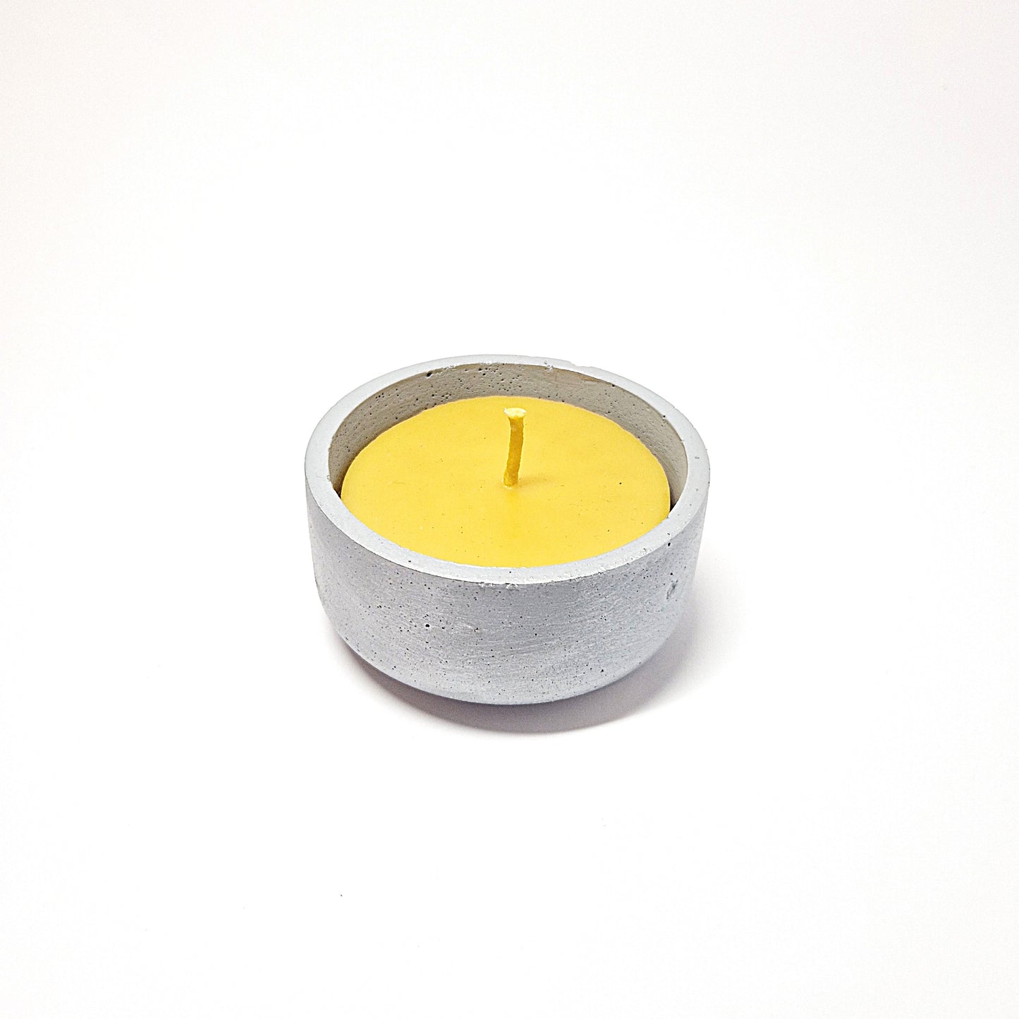 Beeswax candle in a concrete jar