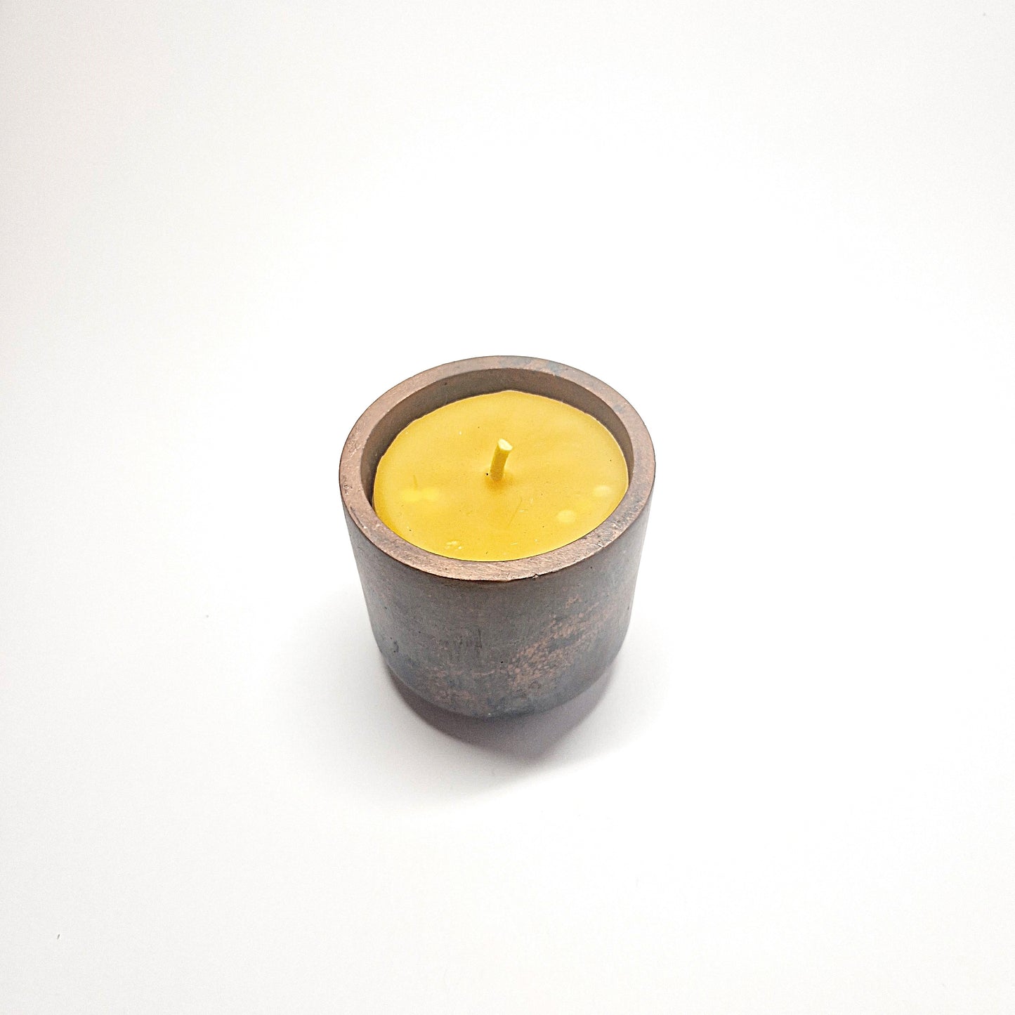 Beeswax candle in a concrete jar